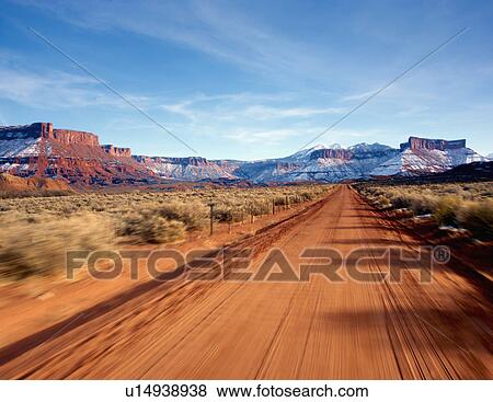Stock Photo - Desolate road through the desert. Fotosearch