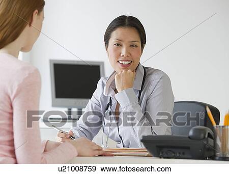 Stock Photo - Doctor and patient consultation. Fotosearch