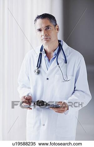 Doctor holding chart View Large Photo Image Stock Photography - Doctor holding chart. Fotosearch