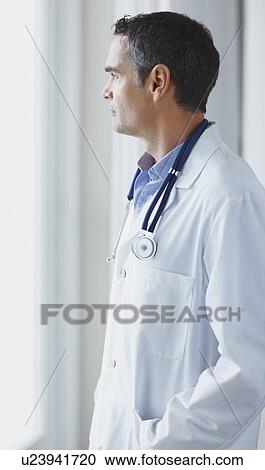 Doctor looking out window View Large Photo Image Stock Image - Doctor looking out window. Fotosearch