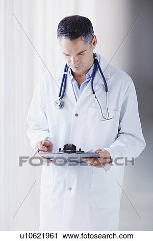 Doctor reading chart View Large Photo Image Stock Image - Doctor reading chart. Fotosearch