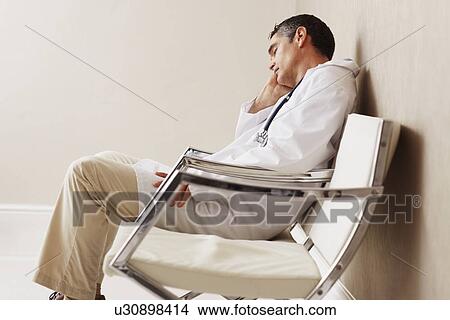 Doctor sitting in waiting room View Large Photo Image Picture - Doctor sitting in waiting room. Fotosearch