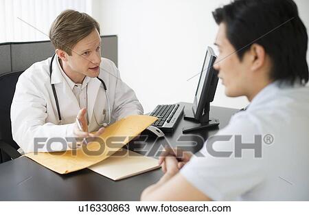 Stock Image - Doctor talking to patient. Fotosearch