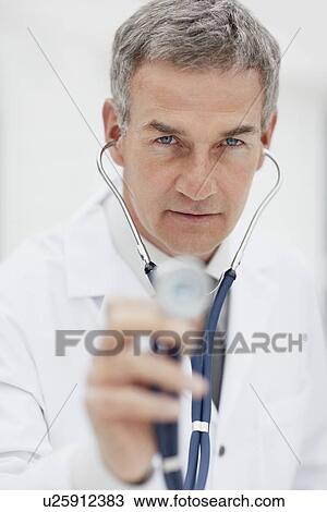 Stock Image - Doctor using stethoscope. Fotosearch