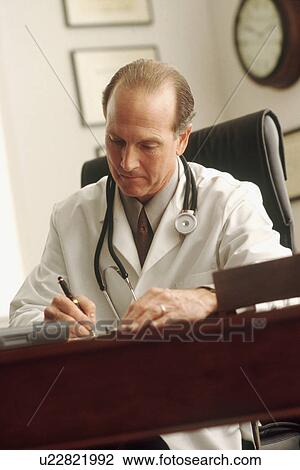 Doctor writing a prescription View Large Photo Image Stock Image - Doctor writing a prescription. Fotosearch