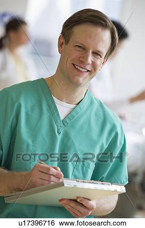 Stock Photograph - Doctor writing on chart. Fotosearch