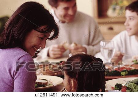 Family eating dinner at home View Large Photo Image Stock Image - Family eating dinner at home. Fotosearch
