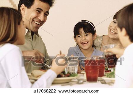 Family eating dinner together View Large Photo Image Stock Image - Family eating dinner together. Fotosearch