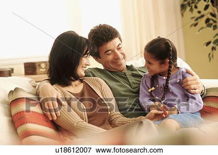 Stock Photo - Family relaxing at home. Fotosearch