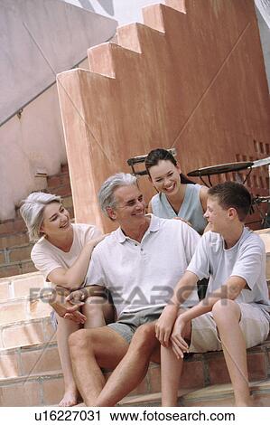 Family sitting on steps together View Large Photo Image Stock Image - Family sitting on steps together. Fotosearch
