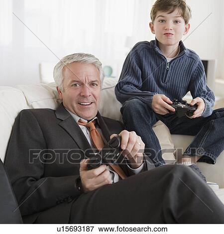 Father and son playing video game View Large Photo Image Stock Photo - Father and son playing video game. Fotosearch