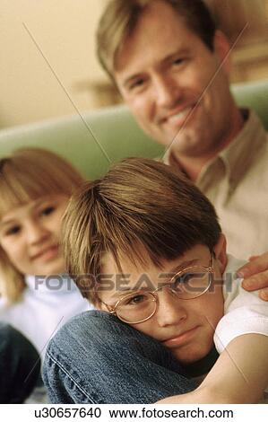 Stock Image - Father sitting with his children. Fotosearch