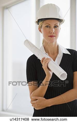 Female architect holding blueprints View Large Photo Image Stock Photo - Female architect holding blueprints. Fotosearch