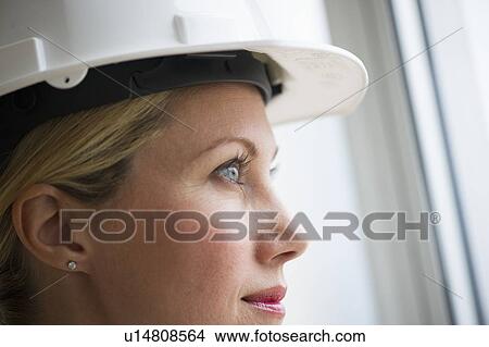 Picture - Female architect wearing a hard hat. Fotosearch
