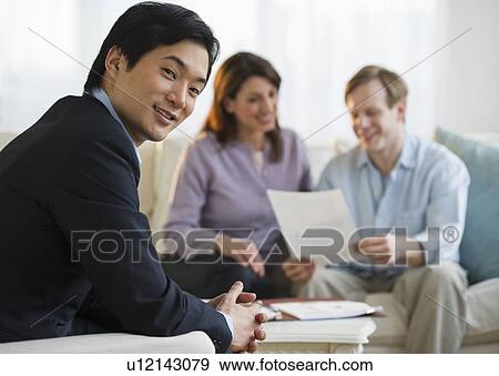 Financial planner and couple at home consultation View Large Photo Image Stock Photo - Financial planner and couple at home consultation. Fotosearch