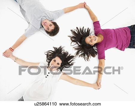 Stock Image - Friends holding hands in a circle. Fotosearch