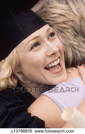 Graduate embracing her mother View Large Photo Image Stock Photograph - Graduate embracing her mother. Fotosearch