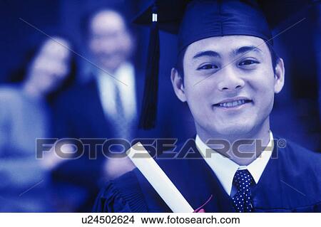 Graduate holding his diploma View Large Photo Image Picture - Graduate holding his diploma. Fotosearch