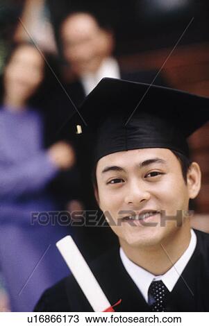 Graduate holding his diploma View Large Photo Image Stock Image - Graduate holding his diploma. Fotosearch