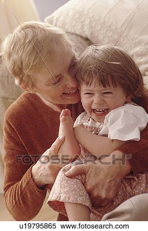 Stock Photography - Grandmother playing with granddaughter. Fotosearch