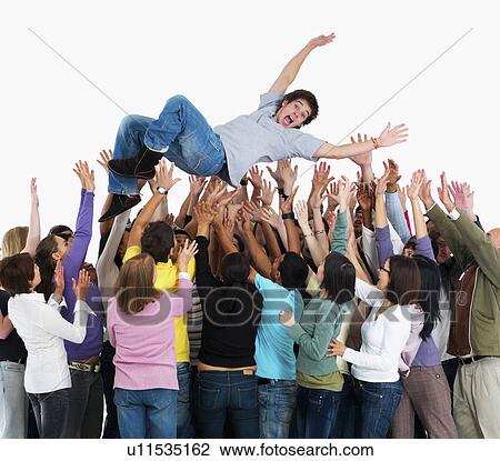 Stock Image - Group of people carrying man. Fotosearch