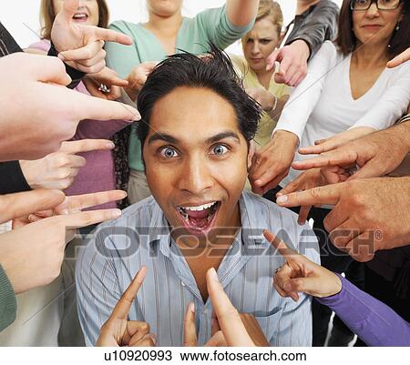 Group of people pointing at one person View Large Photo Image Stock Image - Group of people pointing at one person. Fotosearch