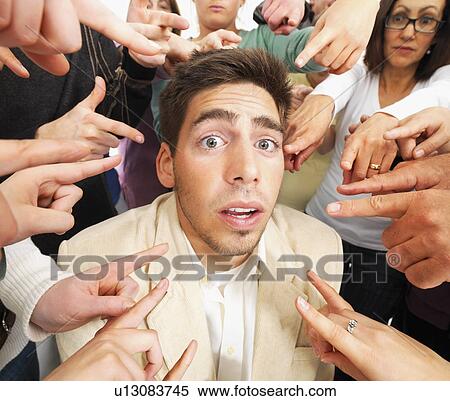 Stock Photography - Group of people pointing at one person. Fotosearch