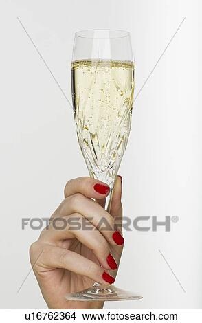 Picture - Hand holding champagne glass. Fotosearch