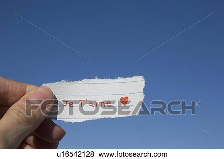 Stock Photo - Hand holding French I love you note. Fotosearch