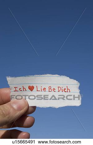Stock Image - Hand holding German I love you note. Fotosearch
