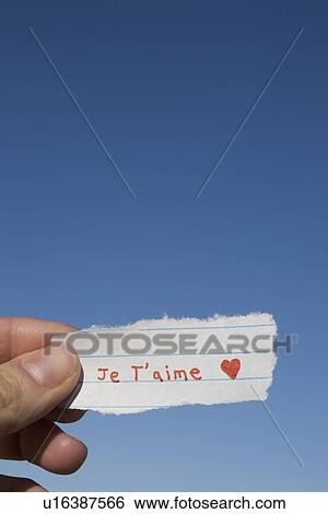 Hand holding I love you note written in French View Large Photo Image Stock Photograph - Hand holding I love you note written in French. Fotosearch