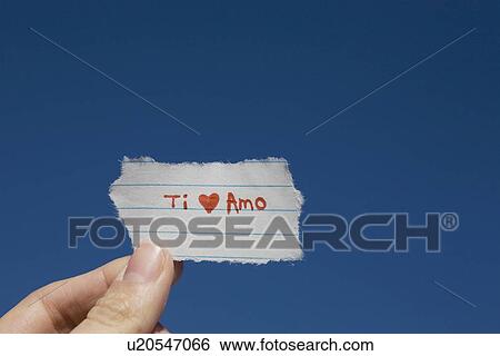 Stock Photograph - Hand holding I love you note written in Spanish. Fotosearch