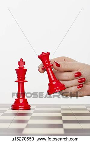 Hand holding red chess piece View Large Photo Image Stock Image - Hand holding red chess piece. Fotosearch
