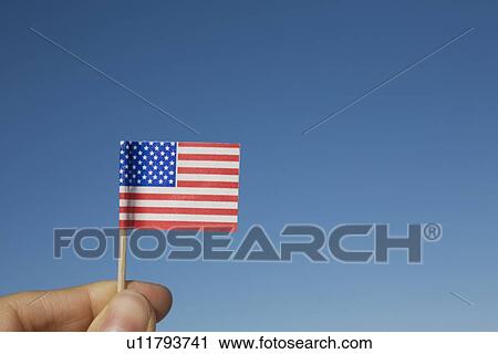 Hand holding small American flag View Large Photo Image Stock Image - Hand holding small American flag. Fotosearch