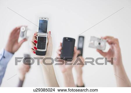 Hands holding wireless devices View Large Photo Image Picture - Hands holding wireless devices. Fotosearch