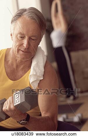 Man exercising with a dumbbell View Large Photo Image Stock Photo - Man exercising with a dumbbell. Fotosearch