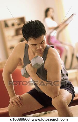 Stock Photograph - Man exercising with a dumbbell. Fotosearch