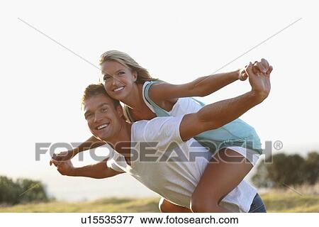 Man giving girlfriend a piggy back ride View Large Photo Image Stock Photo - Man giving girlfriend a piggy back ride. Fotosearch