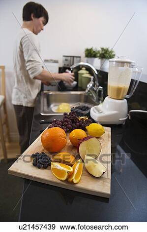 Stock Photo - Man making smoothie. Fotosearch