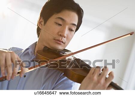Stock Photo - Man playing a violin. Fotosearch