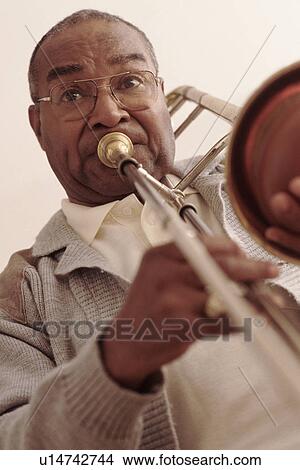 Man playing the trombone View Large Photo Image Picture - Man playing the trombone. Fotosearch