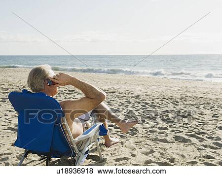 Stock Photo - Man relaxing in beach chair. Fotosearch