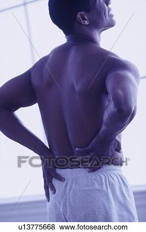 Man with a strained back View Large Photo Image Stock Photo - Man with a strained back. Fotosearch