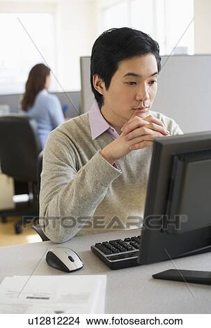 Man working in cubicle View Large Photo Image Picture - Man working in cubicle. Fotosearch