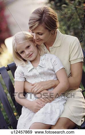 Mother and daughter embracing in the garden View Large Photo Image Stock Photo - Mother and daughter embracing in the garden. Fotosearch