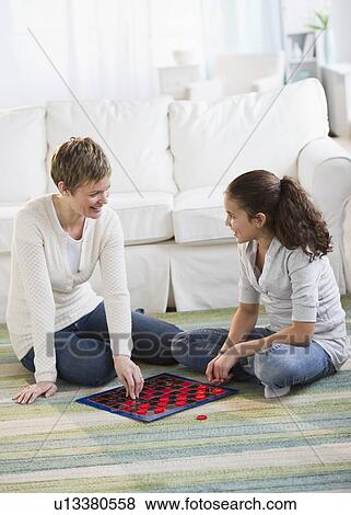 Mother and daughter playing checkers View Large Photo Image Stock Photo - Mother and daughter playing checkers. Fotosearch