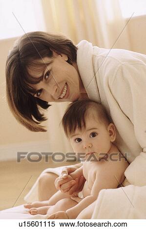 Stock Photography - Mother cuddling with her baby. Fotosearch