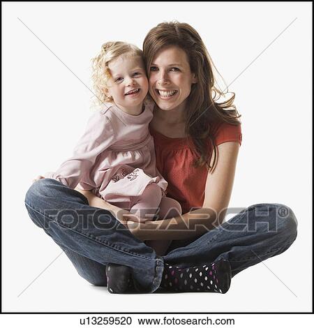 Mother holding daughter in her lap View Large Photo Image Stock Image - Mother holding daughter in her lap. Fotosearch