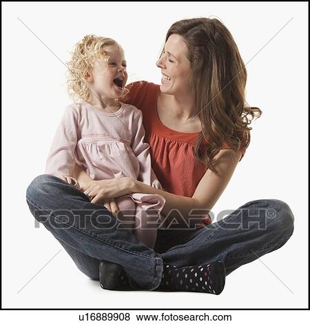 Mother holding daughter in her lap View Large Photo Image Stock Photo - Mother holding daughter in her lap. Fotosearch