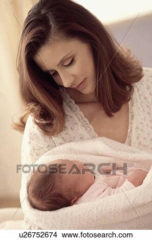 Picture - Mother holding her newborn baby. Fotosearch